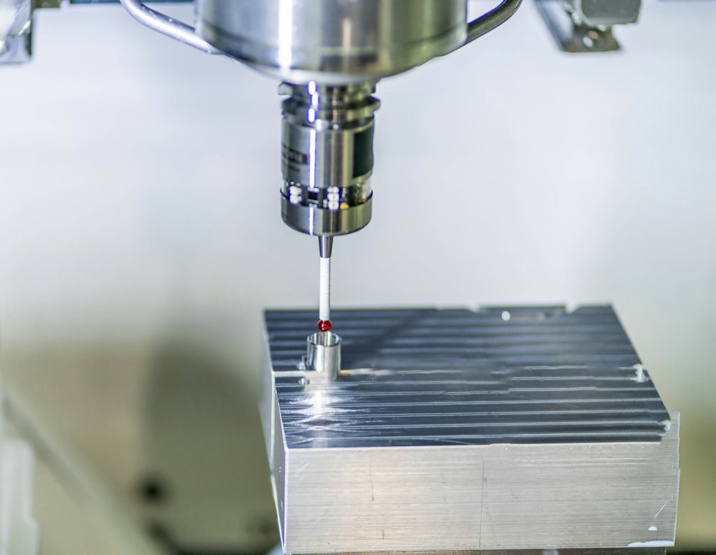 CNC spindle probe positioned above a machined metal component