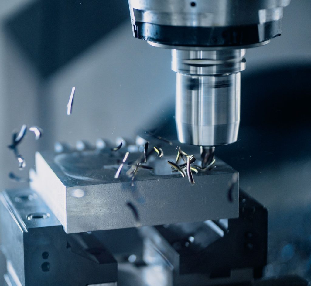Rotating milling tool cutting a clamped workpiece with chips around the cutter